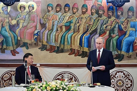 Russian President Vladimir Putin(R), delivers his speech as Chinese President Xi Jinping listens to him during their dinner at The Palace of the Facets in the Moscow Kremlin, Russia. (Photo | AP)