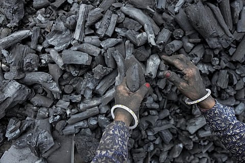A woman works at a coal depot in Ahmedabad. (File | AP)