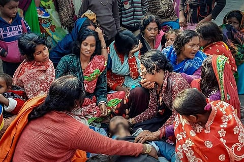 Family members mourn near the mortal remains of the hooch tragedy victims in Bihar's Saran district, January 9, 2024.