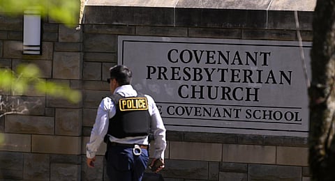A police officer walks by an entrance to The Covenant School after a shooting in Nashville. (Photo | AP)