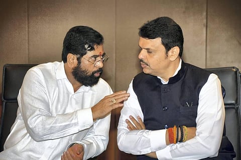 Maharashtra CM Eknath Shinde (L) talks with Deputy Chief Minister Devendra Fadnavis in Mumbai. (File Photo | PTI)