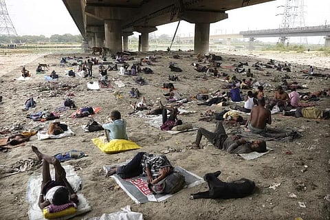 FILE - Homeless people sleep in the shade of an overpass to beat the heat wave in New Delhi, May 20, 2022. (Photo | AP)