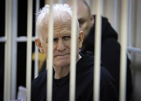 Ales Bialiatski, the head of Belarusian Vyasna rights group, sits in a defendants' cage during a court session in Minsk, Belarus, on Thursday Jan. 5, 2023. (Photo | AP)
