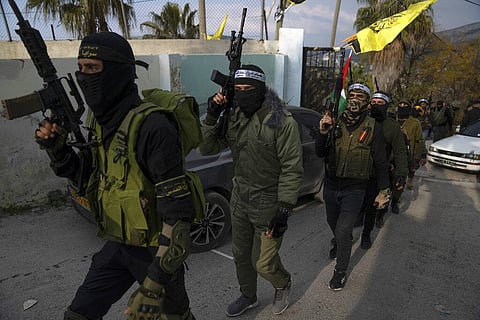Palestinian militants take part in a military parade during a memorial ceremony commemorating their late comrades who were killed during an Israeli army raid on Jan. 14, 2023. (Photo | AP)