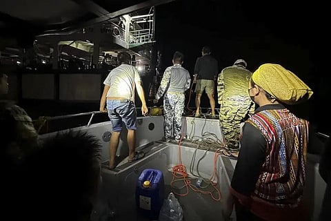 The Philippine Coast Guard personnel (In this photo provided by them) search for survivors from the fire on MV Lady Mary Joy at Basilan, southern Philippines early Thursday March 30, 2023. (Via | AP)