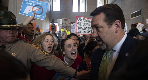 Addie Brue, Madeline Lederman, shout with other protesters as Rep. Jeremy Faison, R-Cosby, Chairman of the House Republican Caucus, walks at the State Capitol Building in Nashville. (Photo | AP)