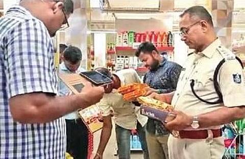  Police and other officials during the raid 