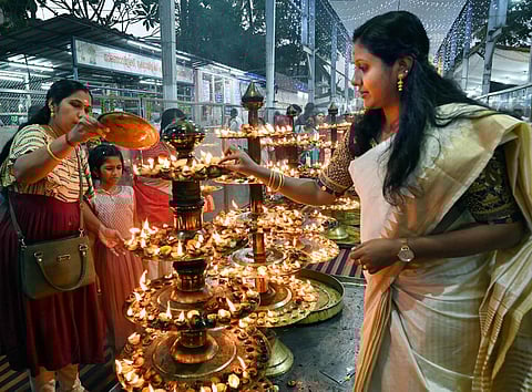 Devotees lighting lemon lamps aka ‘Naranga Vilakku’ at the Attukal Devi Temple in Thiruvananthapuram on Saturday. Lighting them during the festival days is said to be auspicious. | Vincent Pulickal