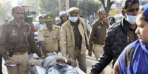 Vijay alias Usman, an accused in the Umesh Pal murder case, being brought to a hospital after being shot in an encounter by police personnel, in Prayagraj district. (Photo | PTI)