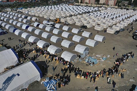 People who lost their houses in the devastating earthquake, lineup to receive aid supplies at a makeshift camp, in Iskenderun city, southern Turkey, Tuesday, Feb. 14, 2023. (File Photo | AP)
