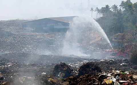 Fire and Rescue Services personnel from BPCL dousing the fire at Brahmapuram waste treatment plant. (Photo | T P Sooraj, EPS)