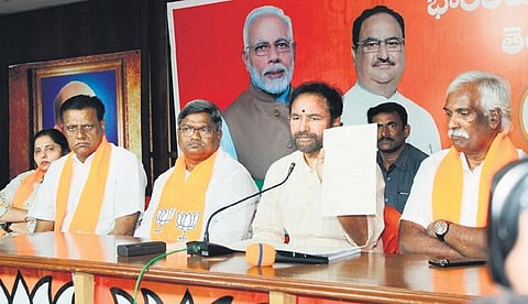 Union Minister of Tourism and Culture G Kishan Reddy shows a document as he addresses the media at the BJP State Office in Hyderabad on Tuesday