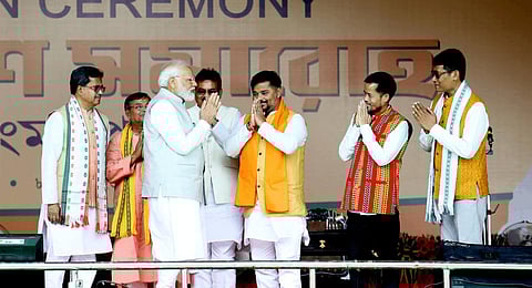 Prime Minister Narendra Modi with newly sworn-in Tripura Chief Minister Manik Saha and Cabinet Ministers during the swearing-in ceremony of Saha, in Agartala.(Photo | PTI)