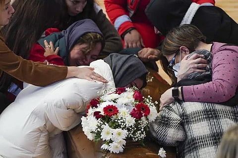 Relatives cry on the coffin of one of the victims of February 26, 2023 shipwreck at the local sports hall in Crotone, southern Italy, Wednesday, March 1, 2023. (Photo | AP)