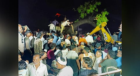 Rescue operation underway after a tree fell on a temporary shed due to strong winds and rain, in a temple premises at Paras village, in Akola district. (Photo | PTI)
