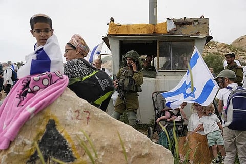 Israeli stand in outpost of Eviatar in the West Bank, Monday, April 10, 2023. (Photo | AP)