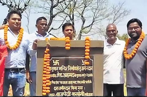 Two brothers with Hindu leaders after handing over their land.