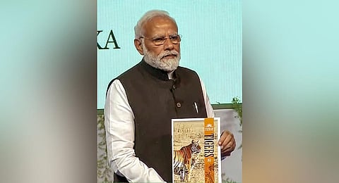 Prime Minister Modi releases the 'Tiger Census' data at a session of commemoration of 50 years of Project Tiger, at Mysuru University, in Mysuru, on April 9, 2023. (Photo | PTI)