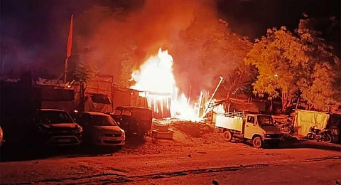 A fire set by miscreants during a clash between two groups in Shastri Nagar area of Jamshedpur, Sunday, April 9, 2023. (PTI)