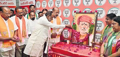 BJP MP K Laxman offers floral tributes to Jyotiba Phule on his birth anniversary at the party head office on Tuesday in the presence of party senior leaders