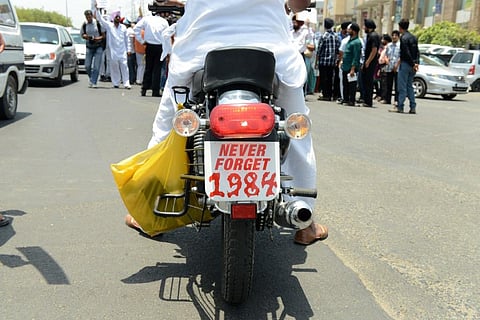 A photo of an Indian Sikh on a motorbike with a placard as a licence plate saying 'never forget 1984', used for representative purposes only. (File Photo | AFP)