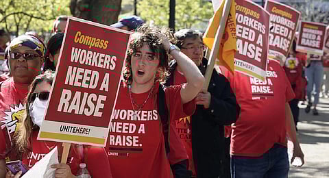 Workers who are contracted to feed World Bank employees through a firm called the Compass Group, protest for higher wages and affordable healthcare benefits. (Photo | AP)