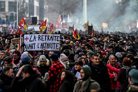 A protestor holds a placard which reads as 'retirement before arthritis' during a rally in Lyon, south-eastern France on January 19, 2023. (File Photo | AFP)