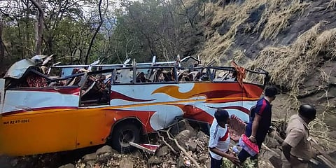 Wrecked remains of a bus that fell into a gorge leaving at least 13 persons dead and 29 others injured on Mumbai-Pune highway, in Raigad district on April 15, 2023. (Photo | PTI)