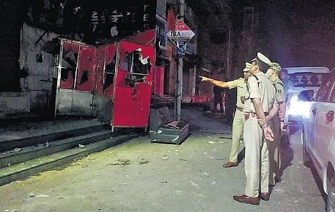 Director General of Police Sunil Kumar Bansal with his team visits areas hit by violence and arson in Sambalpur city, on Saturday | Express