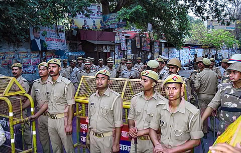 Police stand guard outside a court where three assailants who shot dead gangster-politician Atiq Ahmed and his brother Ashraf were produced in a court, in Prayagraj. (Photo | PTI)