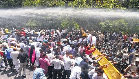 Police use water cannons as BJP workers protest against Chief Minister Arvind Kejriwal over the alleged excise policy scam on Monday | Parveen Negi