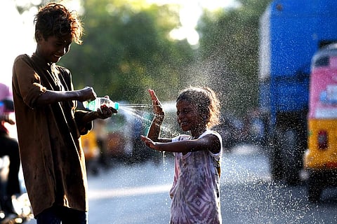 Kids beat the heat by spraying water from a bottle in Chennai. (Photo | P Ravikumar, EPS)