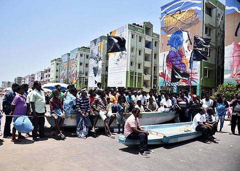 Fishermen and local residents of Nochikuppam continue their protest against the removal of fish stalls on Marina Loop Road in Chennai on Monday. (Photo | P Jawahar, EPS)