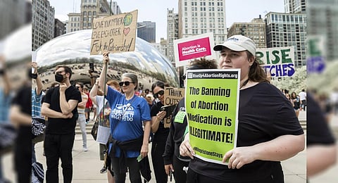 Pro-abortion rights activists hold signs during a rally for abortion rights organized by Rise Up 4 Abortion Rights at Millennium Park in the Loop, Saturday, April 15, 2023, in Chicago. (Photo | AP)