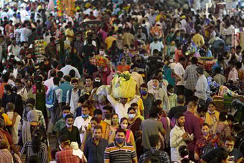 People crowd a market area outside a train station in Mumbai. (File | AP)