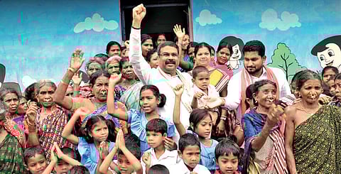 Union minister Dharmendra Pradhan with local villagers after confronting officials of AP at Kotia, on Saturday | Express