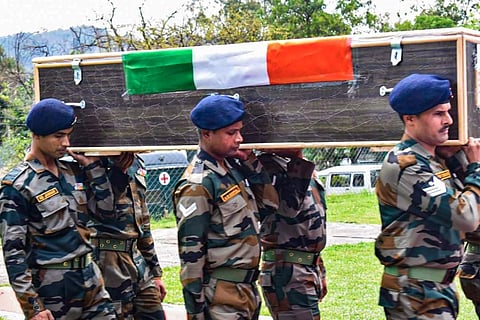 Army officers carry the mortal remains of 5 soldiers who were killed in a terrorist attack for the wreath laying ceremony, in Poonch district, on April 21, 2023. (Photo | PTI)