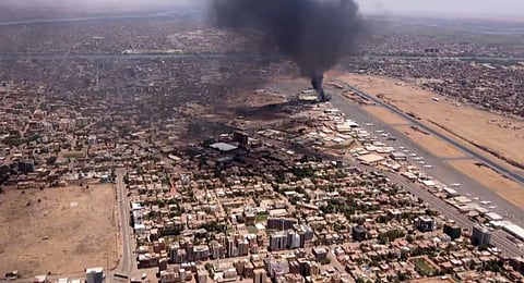 An aerial view of black smoke rising above the Khartoum International Airport amid ongoing battles between the forces of two rival generals. (Photo | AFP)