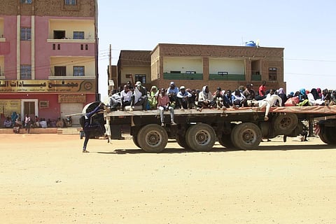 People fleeing street battle between the forces of two rival Sudanese generals, are transported on the back of a truck in the southern part of Khartoum, on April 21, 2023. (Photo | AFP)