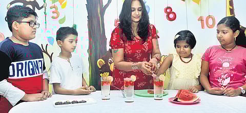 Home chef Priya Kolassery prepares summer coolers and popsicles with children at Tagore Kindergarten, Kumarapuram. | B P Deepu