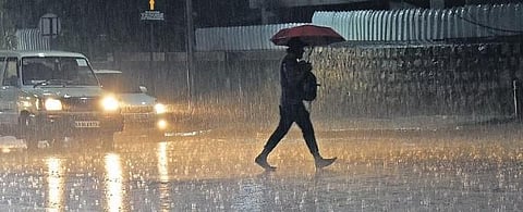 A man runs across a street amid rain in Bengaluru on Friday night | Vinod Kumar T