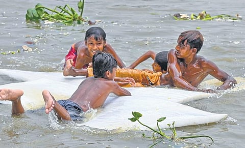 Boys swim in Hooghly river to beat the heat on a hot summer day in Kolkata | pti