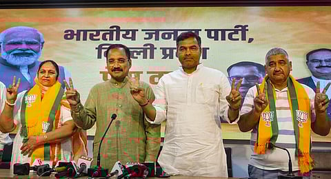 Aam Aadmi Party (AAP) councillor Sunita with former councillor Ramnivas joins the Bharatiya Janata Party (BJP) in the presence of Delhi BJP President Virendra Sachdeva.(Photo | PTI)