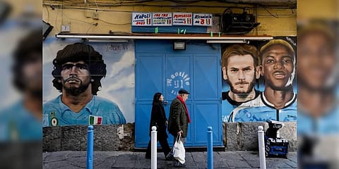 People walk past murals of Napoli's former and present stars, (from L) Diego Maradona, Khvicha Kvaratskhelia and Victor Osimhen, in downtown Naples, April 19, 2023. (Photo | AP)