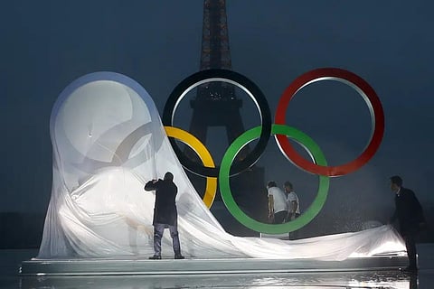 Paris officials unveil a display of the Olympic rings on Trocadero plaza that overlooks the Eiffel Tower in Paris, France. (Photo | AP)