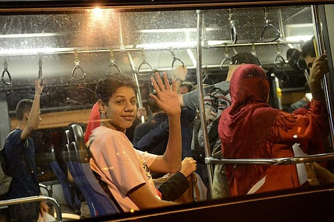 People wave from a bus after arriving in a military plane from Khartoum at the Houari-Boumediene airport in Algiers. (Photo | AP)