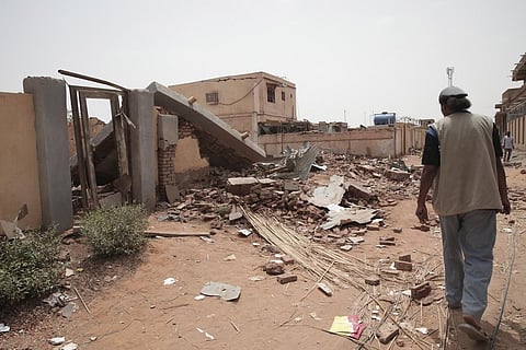 A man walks by a house hit in recent fighting in Khartoum, Sudan on Tuesday, April 25, 2023. (Photo | AP)