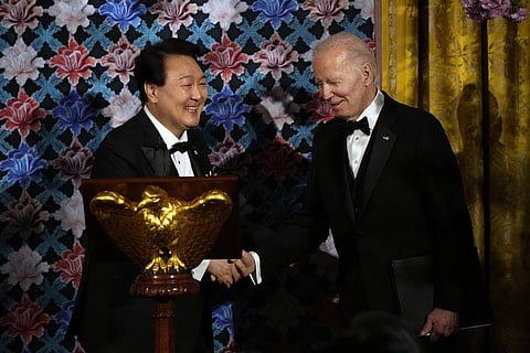 President Joe Biden shakes hands with South Korea's President Yoon Suk Yeol before a toast during a State Dinner in the East Room of the White House in Washington. (Photo | AP)