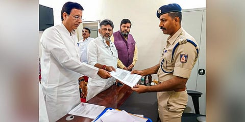 Congress leaders Randeep Singh Surjewala, DK Shivakumar and others file a complaint against Union Home Minister Amit Shah for allegedly spreading enmity and hatred, in Bengaluru. (Photo | PTI)