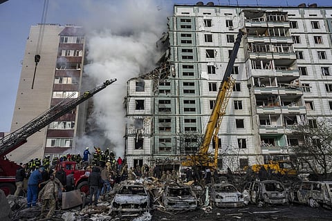 Firefighters work to extinguish a fire after a Russian attack at a residential building in Uman, central Ukraine on Friday, April 28, 2023. (Photo | AP)